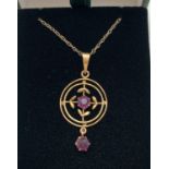 A 9ct gold Art Nouveau style pendant set with amethyst stones, on an 18" rope chain. Circular shaped