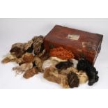 Brown leather suitcase containing a collection of wigs, the case with Cunard White Star line luggage