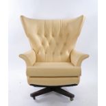 G-Plan 'Blofeld' cream leather swivel chair, with an arched button back above the curved arms and