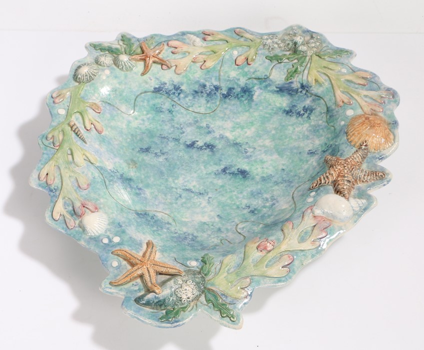 Pottery dish with starfish, shell and seaweed decorated border, initialled AW to base, 35cm wide