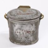 Tin and brass cream container, of oval form with brass swing handle, the hinged lid stamped "34 34