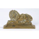 Brass recumbent lion door stop, 18cm wide, 10cm high