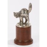 White metal cat car mascot, on a later turned wooden base, the mascot 8.5cm high, 15cm high