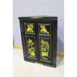 Mid 20th Century ebonised corner cupboard, the panelled doors decorated with Asian scenes, 98cm