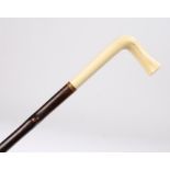 Victorian ivory cane, with a delicate curved handle above a slender cane with knots, 86cm high