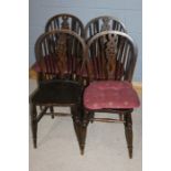 Set of four Edwardian Windsor style chairs, the pierced splats above turned legs, united by
