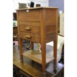 Edwardian oak sewing box, with hinged compartment and two frieze drawers above an open recess, on