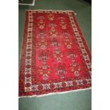 Middle Eastern rug, the red ground with an orange coloured geometric pattern, 120cm x 190cm