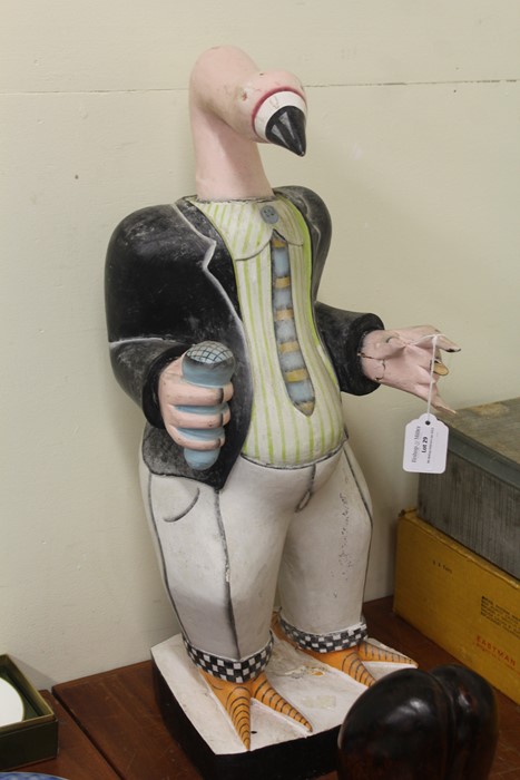 Carved wooden flamingo, depicting a singer holding a microphone, 57cm high