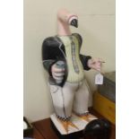 Carved wooden flamingo, depicting a singer holding a microphone, 57cm high