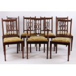 Set of seven Edwardian mahogany dining chairs, with a lattice back above the drop in seat and square