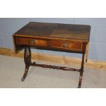 Regency style mahogany sofa table, with two leaves, raised on pierced lyre form supports, turned