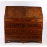 Swiss figured walnut bureau, late 18th/early 19th Century, the elm inlaid top and slopping fall