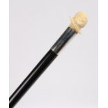 Late 19th Century French ivory cane, caved with a head with wide collar above a white metal collar