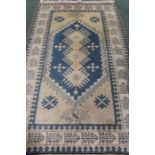 Middle Eastern style rug, the cream and blue ground with geometric patterns within multiple borders,