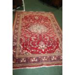 Middle Eastern rug, the red ground with foliate decorations in blue, within pear green borders,