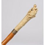 19th Century ivory cane, carved with a lady seated on scrolls above a bamboo cane, 95cm long