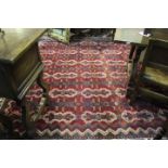 Middle Eastern rug, the red ground decorated with medallions and blue geometric patterns, 360cm x