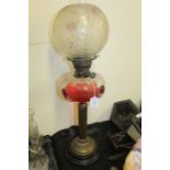 Edwardian oil lamp, with frosted foliate shade above a clear and mottled glass reservoir, raised
