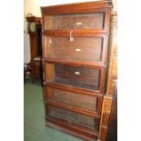 Globe Wernicke five-tier glazed bookcase, with labels to the interior, raised on a plinth base,