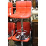 Pair of red faux leather adjustable bar stools (2)