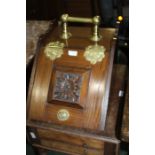 Edwardian mahogany and brass coal purdonium, the brass handle above a hinged compartment with