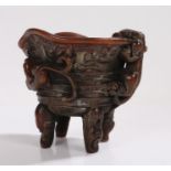 Libation cup with dragon decoration, raised on four scroll decorated legs,12cm high