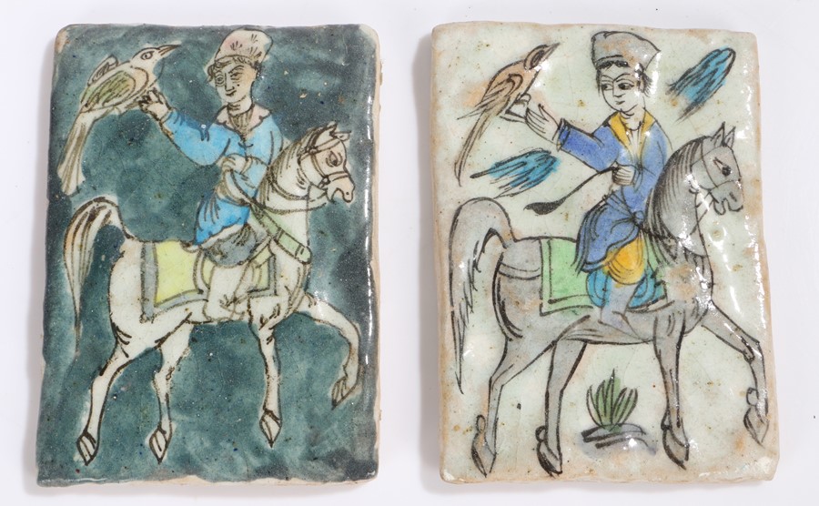 Pair of Eastern tiles decorated with a raised depiction of figure on horseback holding a bird of