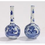 Pair of blue and white spill vases, the slender necks above gadrooned bulbous bodies, with foliate