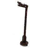 Chinese hardwood standard lamp, the stem carved as a dragon holding the lamp fitting in it's