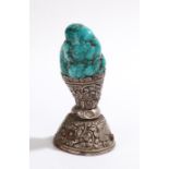 Tibetan seal, the turquoise handle above a white metal foliate and bird decorated base, 10.5cm high