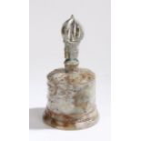 Carved stone bell with pierced figural finial and foliate decoration, 23.5cm high