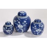 Graduated set of three Japanese ginger jars, with prunus blossom decoration on a blue ground, the