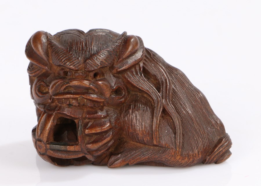 Japanese carved wood netsuke, of shishi holding a pierced ball, signed Masayuki, 4cm longOverall