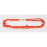 Coral necklace, the two stands of graduated coral beads with an 18 carat gold clasp, 47cm long