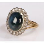 18 carat gold sapphire and diamond set ring, the cabochon sapphire at 9.31 carats surrounded by