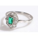 Emerald and diamond set ring, the central emerald at 0.90 carat with a diamond surround estimate