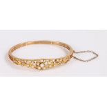 Victorian gold and pearl set bangle, with pearls set to the foliate designed front, 62mm diameter