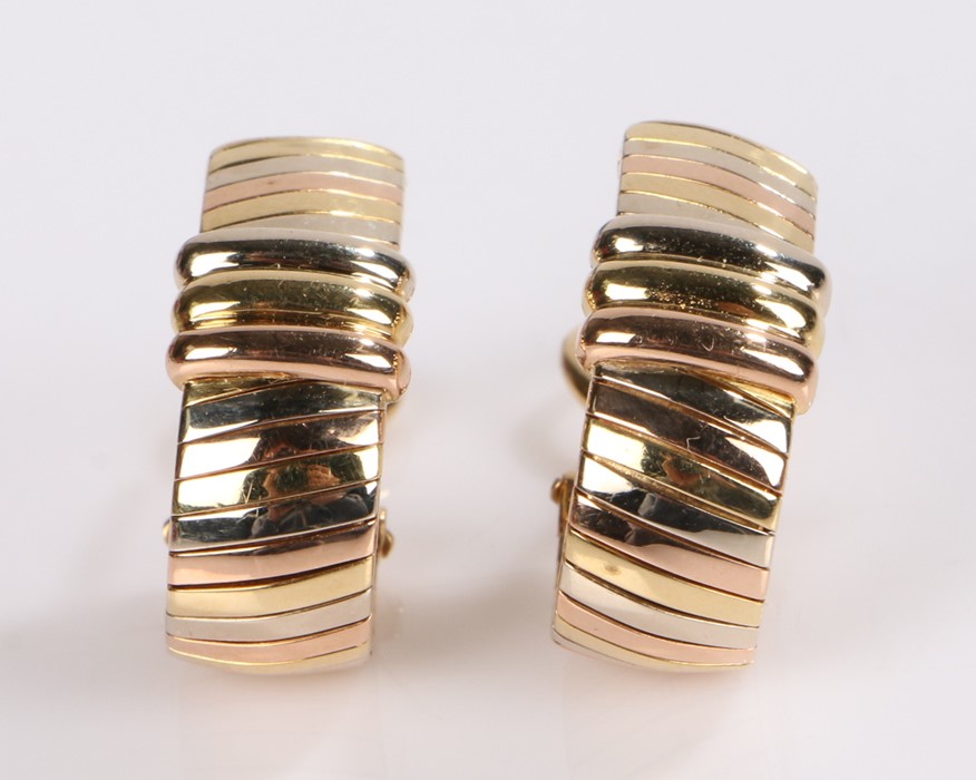 Pair of Cartier earrings, in 18 carat mixed gold with loop design, signed Cartier and numbered