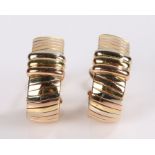 Pair of Cartier earrings, in 18 carat mixed gold with loop design, signed Cartier and numbered