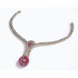 Diamond and ruby set necklace, with a central diamond with carved flower and a pear cut ruby, no