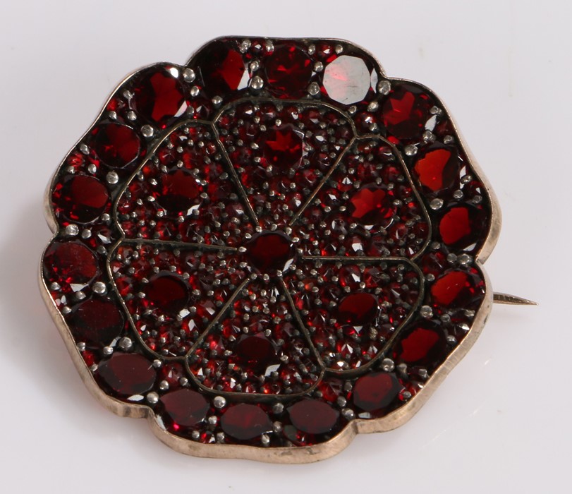 Garnet set brooch, in a wide flower head design, 36mm diameter