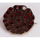 Garnet set brooch, in a wide flower head design, 36mm diameter