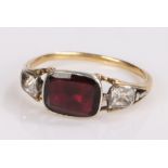 Garnet set ring, the rectangular garnet flanked by two paste stones, ring size J1/2