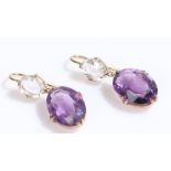 Pair of amethyst earrings, with an oval amethyst and clear stone above, 28mm long