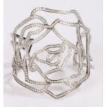 Cavallo diamond set bangle, with a stylised flower head design set with diamonds, 56 grams, 65mm