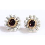 Pair of garnet and enamel earrings, the studs in the form of flower heads with a central garnet,