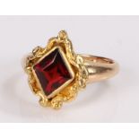 Garnet set ring, the diamond cut garnet with a scroll surround, ring size K