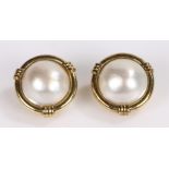 Pair of pearl set earrings, the dome pearls set to the yellow metal mount and clip back, 20mm