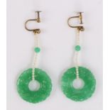 Pair of jade style earrings, the circular discs held to the pearl strands, 27mm diameter